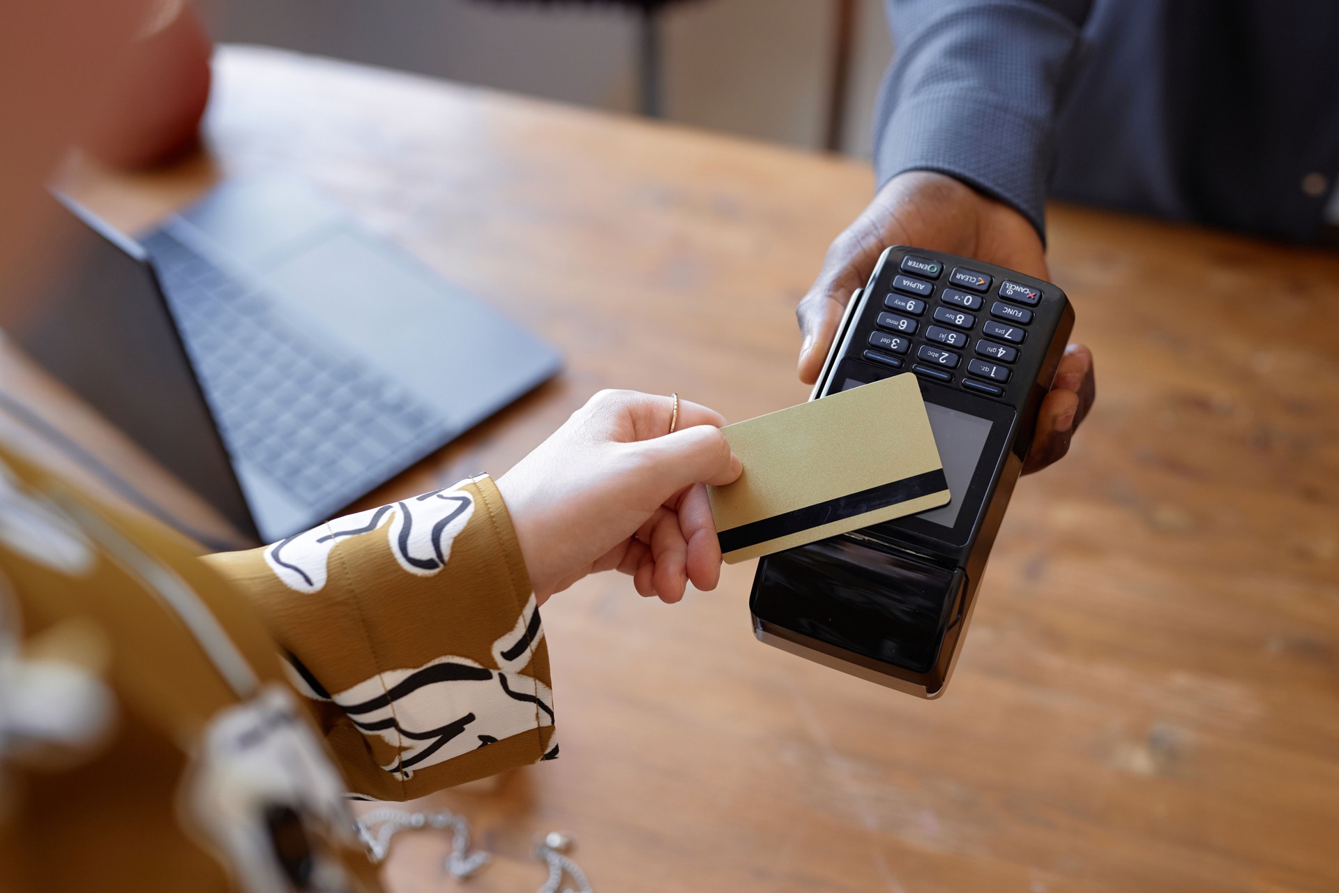 Woman Paying Contactless with Bank Card at Store Checkout